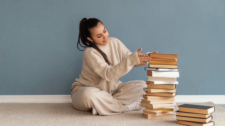 full-shot-woman-stacking-books_23-2148882704.jpg